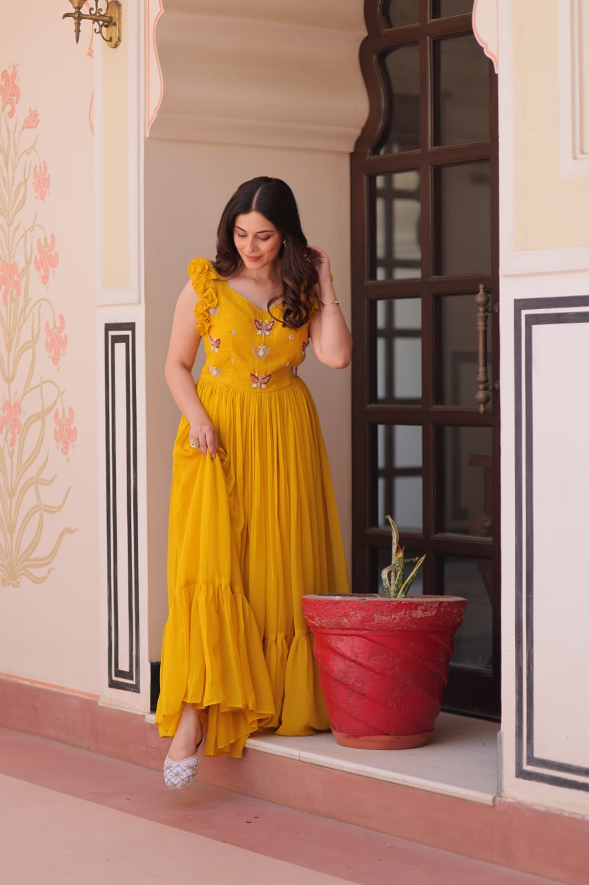 Lavi 7-meter flared designer gown in faux blooming fabric with sequin & bead embroidery, V-neck & frill shoulders – perfect for weddings & parties.